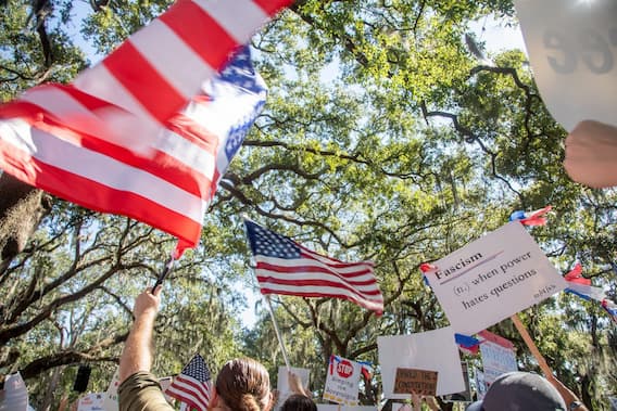 Crowd at rally in Savannah, GA waving American flags in patriotism